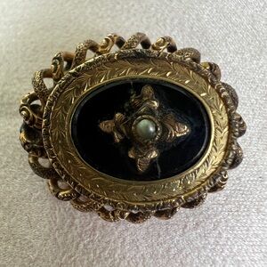 Elegant Gold and Black Brooch